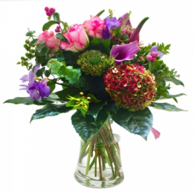 The Country Charm - A seasonal mix in lilacs pinks and purples. This is a florist choice selection and may include hydrangea if in season, berries and calla lilies. Creatively crafted and delivered in a vase your selected local florist 
