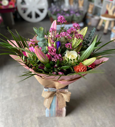 Out in the Woods - A beautiful handtied in water presented in a gift box. To include flowers in pink, purple, white with complimentary foliage.